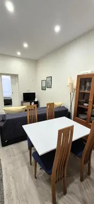 a living room with a table and chairs and a couch at La esquina de los italianos by Gades Gestión in Cádiz