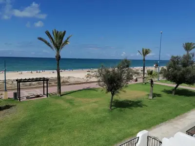 a view of the beach from the balcony of a condo at Barrosa Frente al Mar in Chiclana de la Frontera