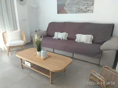 a living room with a couch and a coffee table at CASA LA PLAYA-CONIL Vacaciones de Lujo en Conil con Todas las Comodidades NETFLIX-HBO-DISNEY-CANALES DE FUTBOL-WIFI ALTA VELOCIDAD-SMART TV 65
