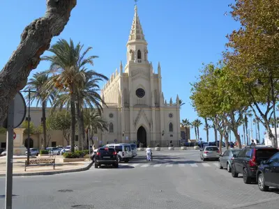 a church with cars parked in front of it at Penthouse on the Costa de la Luz, Air conditioning, beach 300 meters away in Chipiona