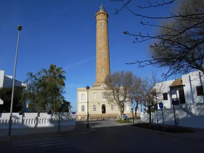 a lighthouse on the side of a street at Penthouse on the Costa de la Luz, Air conditioning, beach 300 meters away in Chipiona