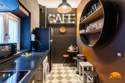 a kitchen with a cafe sign on the wall at Blue Home by Cadiz Time in Cádiz