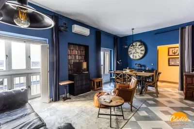 a living room with blue walls and a table at Blue Home by Cadiz Time in Cádiz