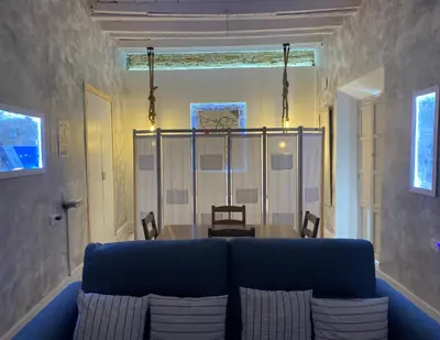 a living room with a blue couch and a table at LA CUEVA DEL LOCO, Bretones 29 in Sanlúcar de Barrameda