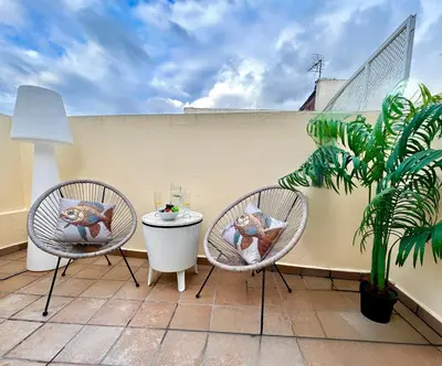 two chairs and a table on a balcony with a plant at GATU Herrería in El Puerto de Santa María