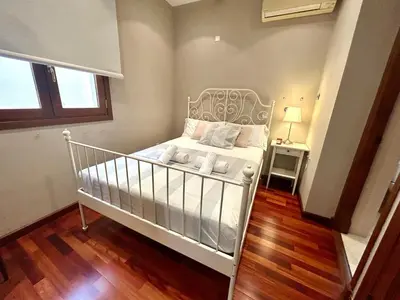 a small bedroom with a white crib in a room at GATU Herrería in El Puerto de Santa María