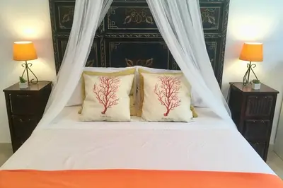 a white bed with two pillows with trees on it at GATU PREMIUM El Puerto Centro aire acc, calefacc, wifi, parking y piscina comun Preferente mayores de 25 años y familias 
