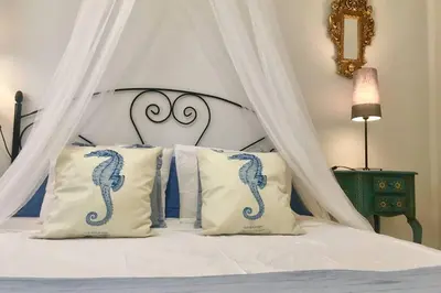a bedroom with a bed with a canopy with pillows at GATU PREMIUM El Puerto Centro aire acc, calefacc, wifi, parking y piscina comun Preferente mayores de 25 años y familias 