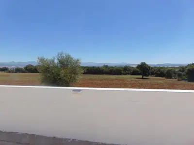 a white wall with a view of a field at Finca La Parrilla in Arcos de la Frontera