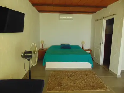 a bedroom with a bed and a flat screen tv at Finca La Parrilla in Arcos de la Frontera