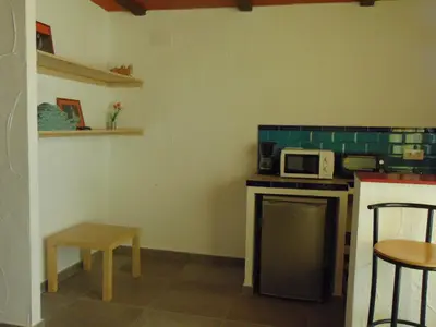 a small kitchen with a counter and a microwave at Finca La Parrilla in Arcos de la Frontera