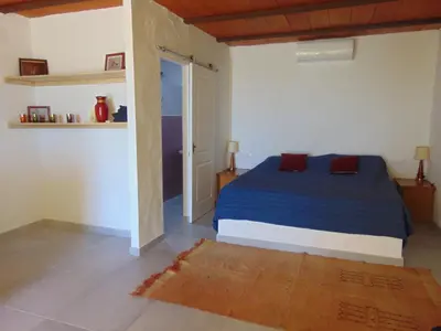 a bedroom with a blue bed in a room at Finca La Parrilla in Arcos de la Frontera