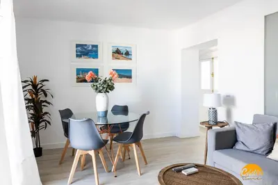 a living room with a table and chairs and a couch at Apartamento Oceano by Cadiz Time in Cádiz
