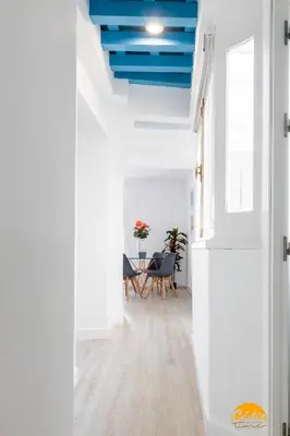 a hallway with a blue ceiling and a table at Apartamento Oceano by Cadiz Time in Cádiz