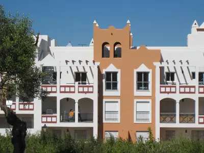 a building with white and orange at Flamingo Golf B in Sanlúcar de Barrameda