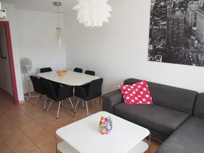 a living room with a couch and a table at Flamingo Golf B in Sanlúcar de Barrameda