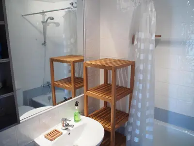 a bathroom with a sink and a shower and a mirror at Flamingo Golf B in Sanlúcar de Barrameda