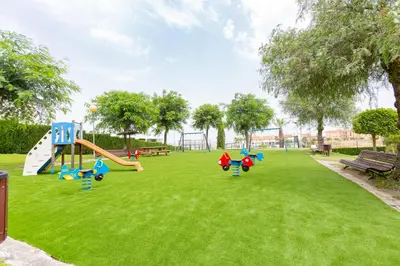 a playground with a slide in a park at Flamingo Golf B in Sanlúcar de Barrameda