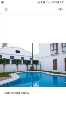 a picture of a swimming pool in front of a building at Atico padre Aldama centro y con WIFI in Sanlúcar de Barrameda