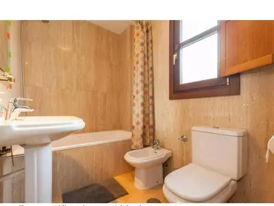 a bathroom with a white toilet and a sink at Atico padre Aldama centro y con WIFI in Sanlúcar de Barrameda