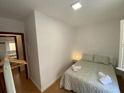a small bedroom with a bed in a room at Sánchez Home, Pleno Centro in Sanlúcar de Barrameda