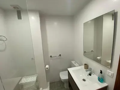a bathroom with a sink and a toilet and a mirror at Sánchez Home, Pleno Centro in Sanlúcar de Barrameda