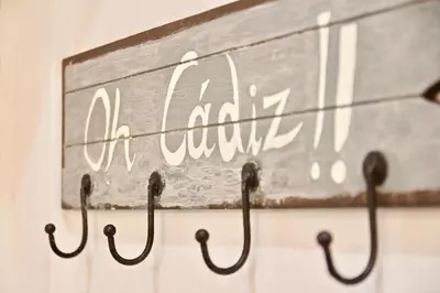 a sign that reads ahmadinejad hanging on a wall at Apartamento Oh Cádiz in Cádiz