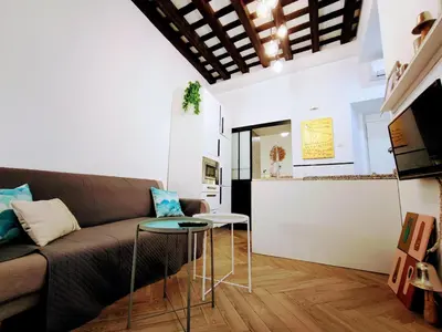 a living room with a couch and a table at Apartamento Oh Cádiz in Cádiz