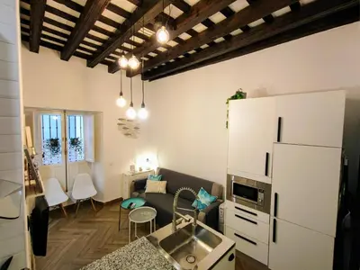 a kitchen with a sink and a living room at Apartamento Oh Cádiz in Cádiz