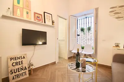 a living room with a flat screen tv on a wall at Apartamento Oh Cádiz in Cádiz