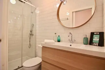 a bathroom with a toilet and a sink and a mirror at Apartamento Oh Cádiz in Cádiz