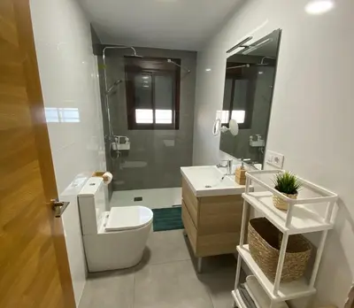 a bathroom with a toilet and a sink and a shower at Chalets Novo Sancti Petri in Chiclana de la Frontera