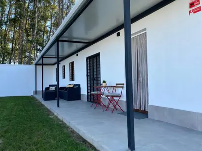 a patio with a table and chairs on a white building at Chalets Novo Sancti Petri in Chiclana de la Frontera