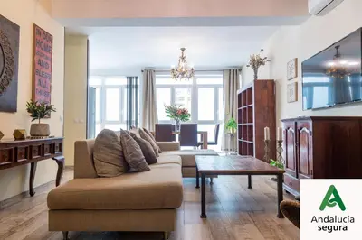 a living room with a couch and a table at La Luz de Cadiz by Cadiz Time in Cádiz