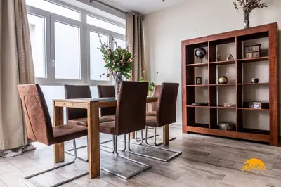 a dining room with a wooden table and chairs at La Luz de Cadiz by Cadiz Time in Cádiz