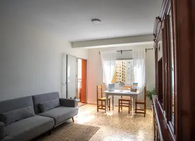 a living room with a couch and a table at Delfín Playa Basic Ha Apartment in Cádiz