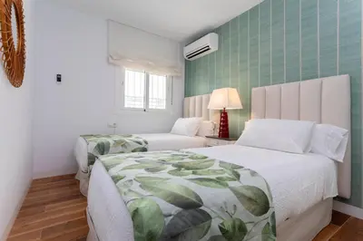 a bedroom with a bed and a couch at Genteel Home San Antonio in Cádiz