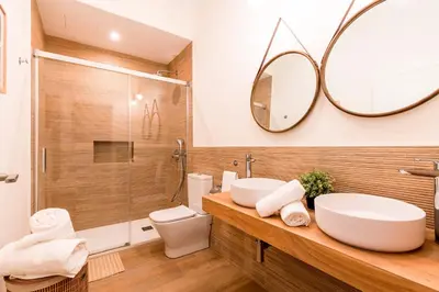 a bathroom with two sinks and a mirror at Genteel Home San Antonio in Cádiz