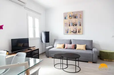 a living room with a couch and a table at Apartamento Vintage by Cadiz Time in Cádiz