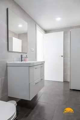a bathroom with a sink and a toilet and a mirror at Apartamento Vintage by Cadiz Time in Cádiz