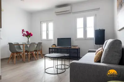 a living room with a couch and a table at Apartamento Vintage by Cadiz Time in Cádiz