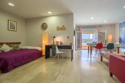 a bedroom with two beds and a balcony at Atico La JOYITA free parking by Cadiz4Rentals in Cádiz