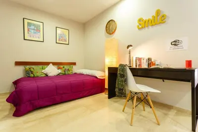 a bedroom with a purple bed and a desk at Atico La JOYITA free parking by Cadiz4Rentals in Cádiz