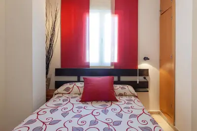 a bedroom with two beds and a dresser in it at Atico La JOYITA free parking by Cadiz4Rentals in Cádiz