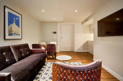 a living room with a couch and a table at Tandem Torres de Cádiz Suites in Cádiz