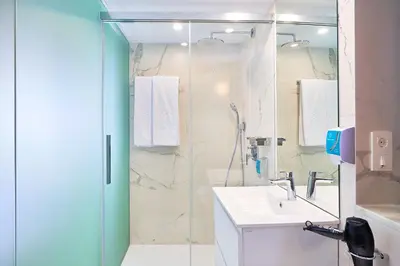 a bathroom with a shower and a sink and a shower at Tandem Torres de Cádiz Suites in Cádiz