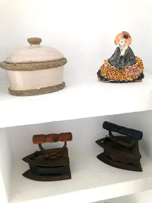 a shelf with different types of items on it at GATU Vista Infinita 1ªlinea mar WIFI, AIRE ACC, TERRAZA CON VISTAS in Cádiz