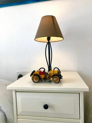 a toy car on a dresser with a lamp on it at GATU Vista Infinita 1ªlinea mar WIFI, AIRE ACC, TERRAZA CON VISTAS in Cádiz