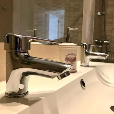 a bathroom sink with a chrome faucet on a counter at GATU Vista Infinita 1ªlinea mar WIFI, AIRE ACC, TERRAZA CON VISTAS in Cádiz