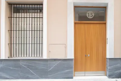 a front door of a building with a sign on it at Apartamento Colon en Cadiz in Cádiz